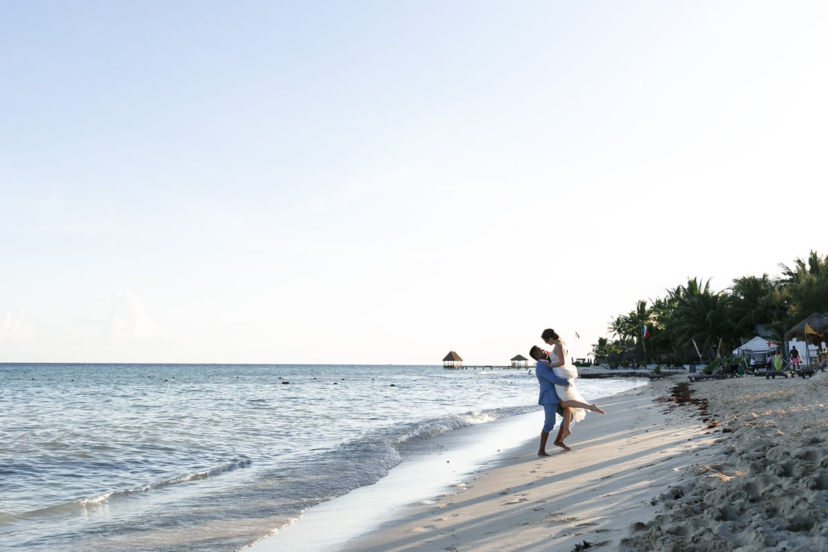 BrideJumpsIntoGroomsArmsOnBeach