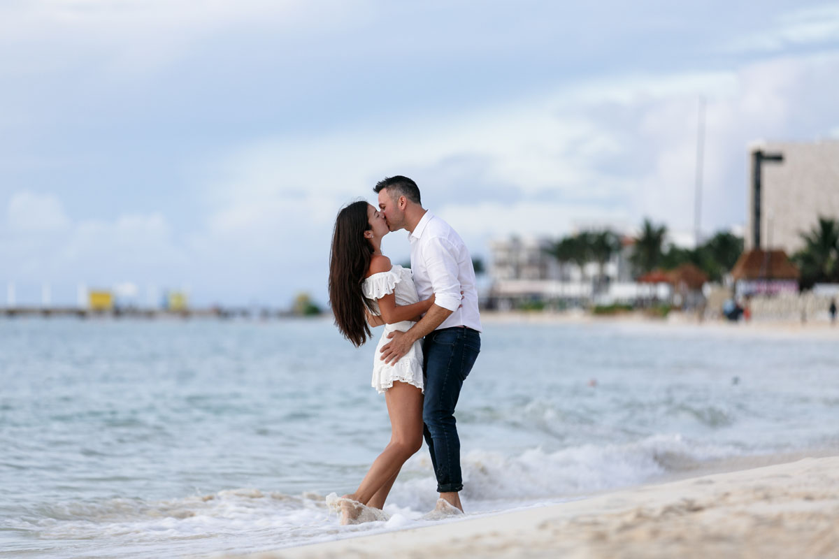 NewlyEngagedCoupleKissOnPdCBeach