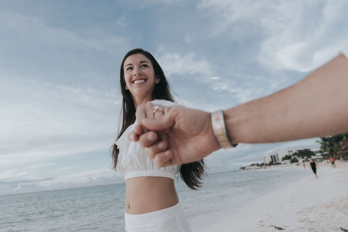 NewlyEngagedCoupleHoldHandsOnPdCBeachWalk