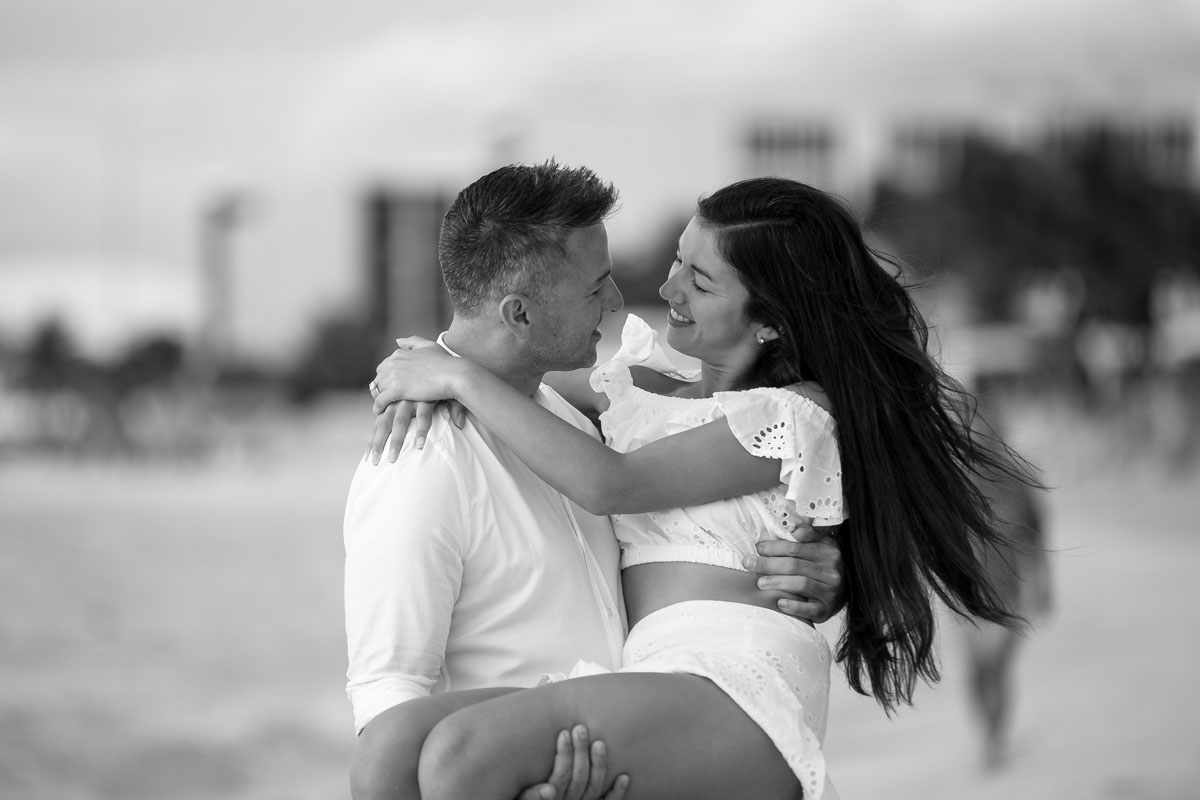 NewlyEngagedCoupleTwirlOnBeach