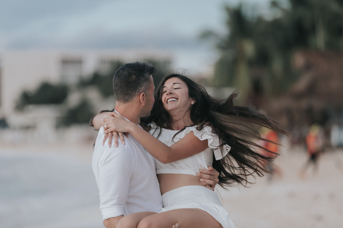 NewlyEngagedCoupleTwirlOnBeach