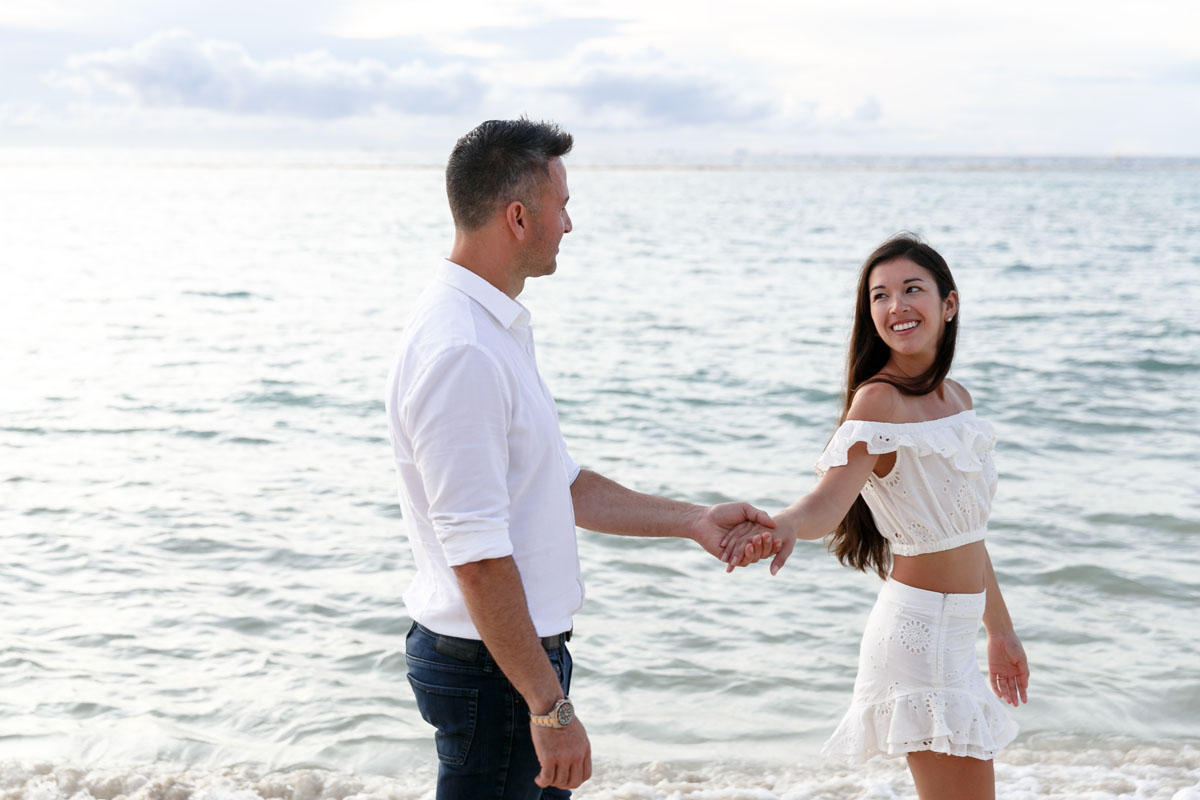 NewlyEngagedCoupleHoldHandsOnPdCBeachWalk