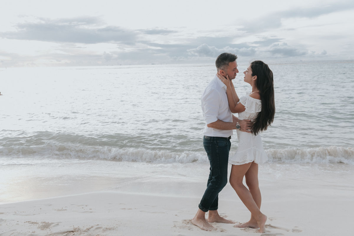 NewlyEngagedCoupleHoldEachOtherOnBeach