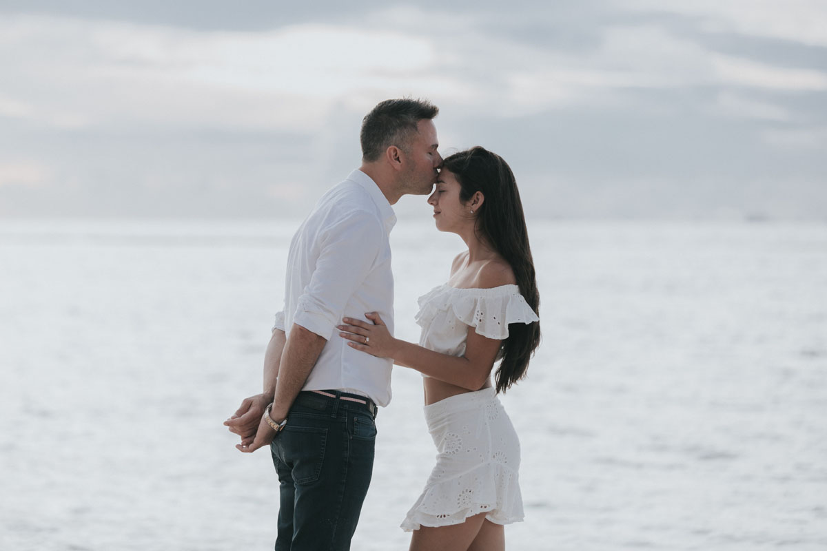 NewlyEngagedCoupleKissOnBeach