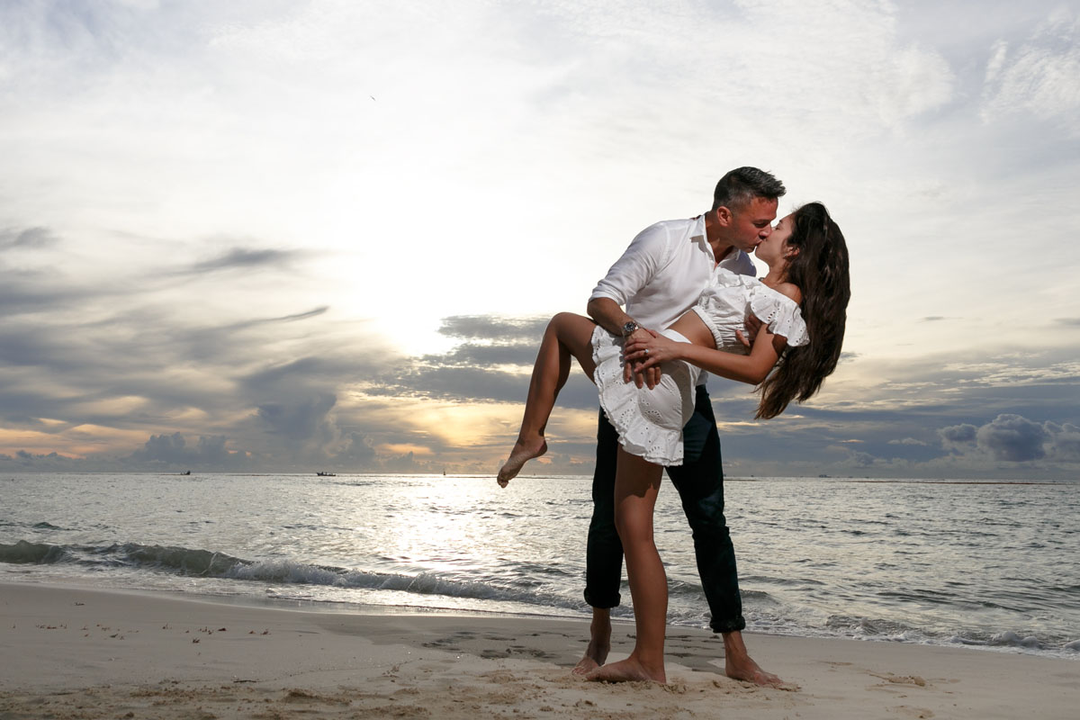 Newly Engaged Couple Kiss on Beach at Sunrise