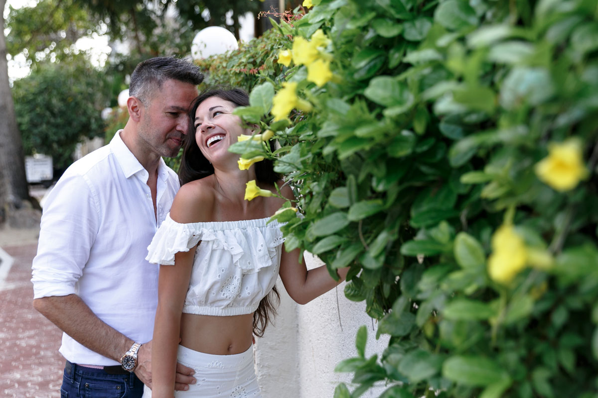 NewlyEngagedCoupleLaughOnSideWalk