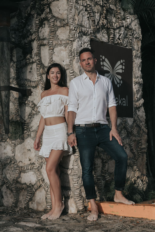 NewlyEngagedCouplePoseByStoneWall