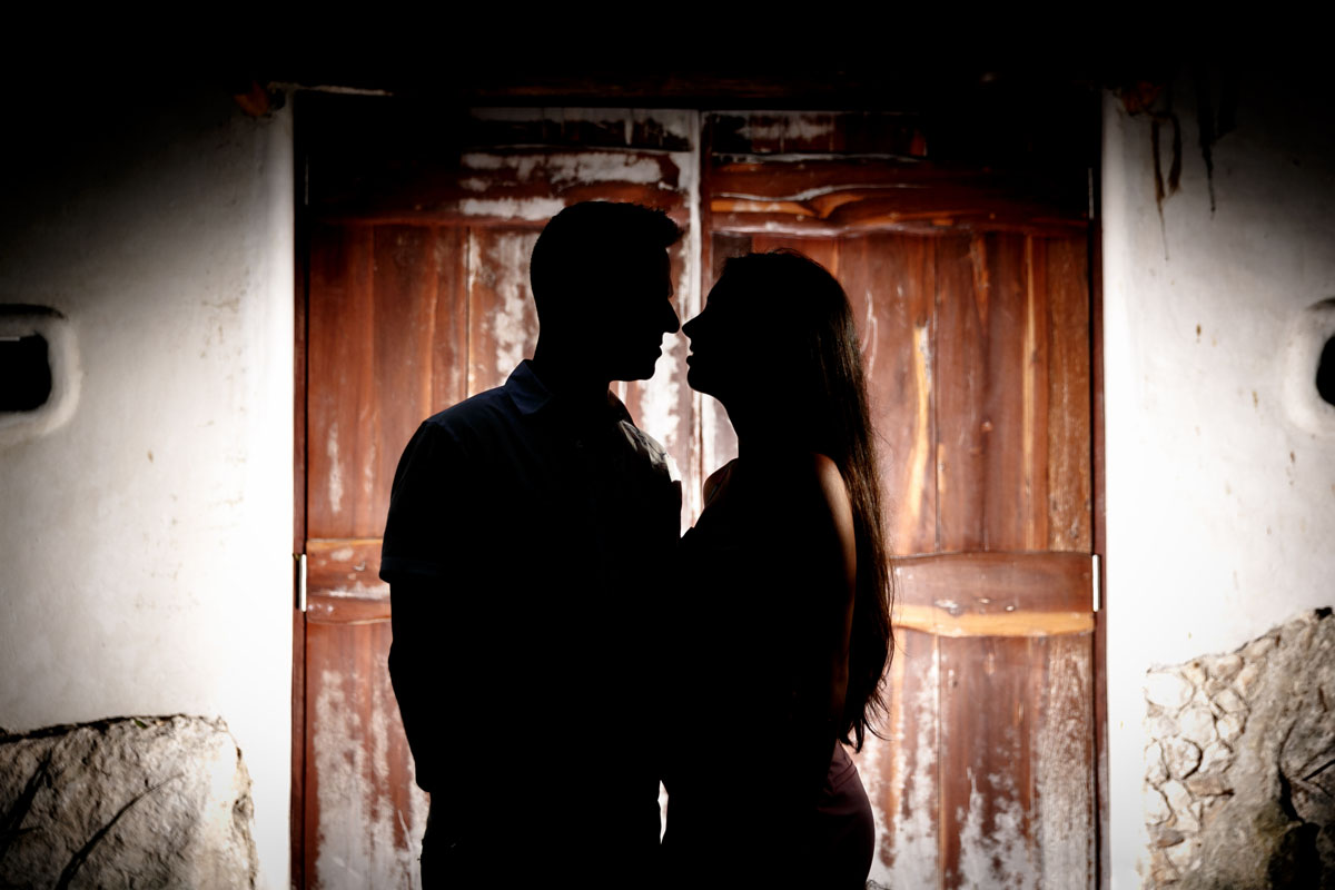 NewlyEngagedCouplePoseByWoodenDoor
