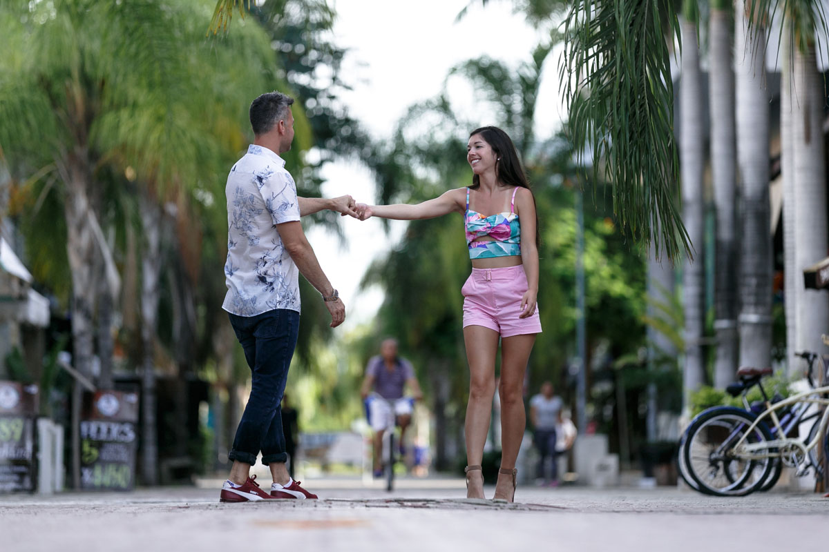 NewlyEngagedCoupleDanceOnCitySidewalk