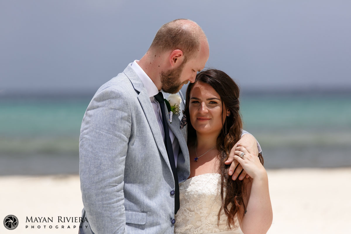 NewlwedsSnuggleOnBeach