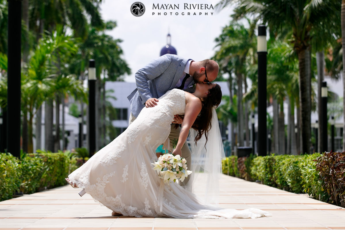 Newlywed husband dips bride in a kiss