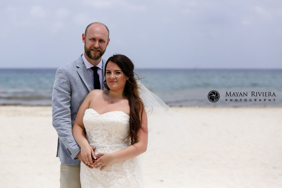 NewlwedsSnuggleOnBeach