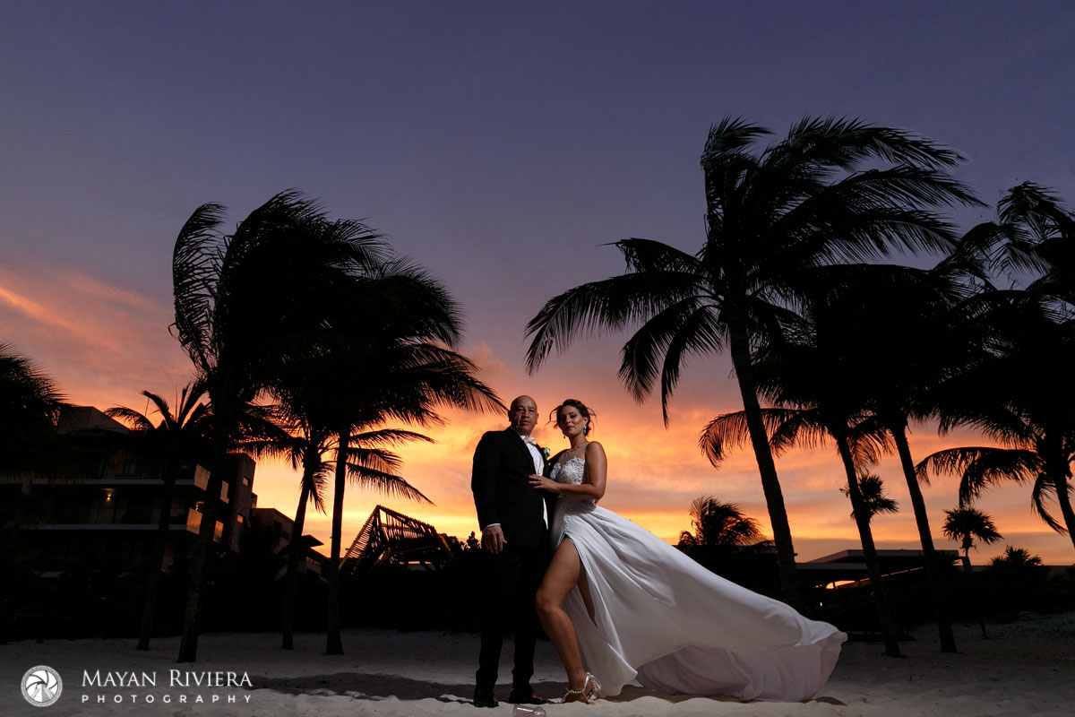 Newlyweds Pose on Royalton Beach shilouetted by stunning sunset