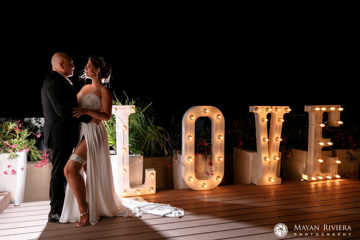 NewlywedsPoseByLoveSign