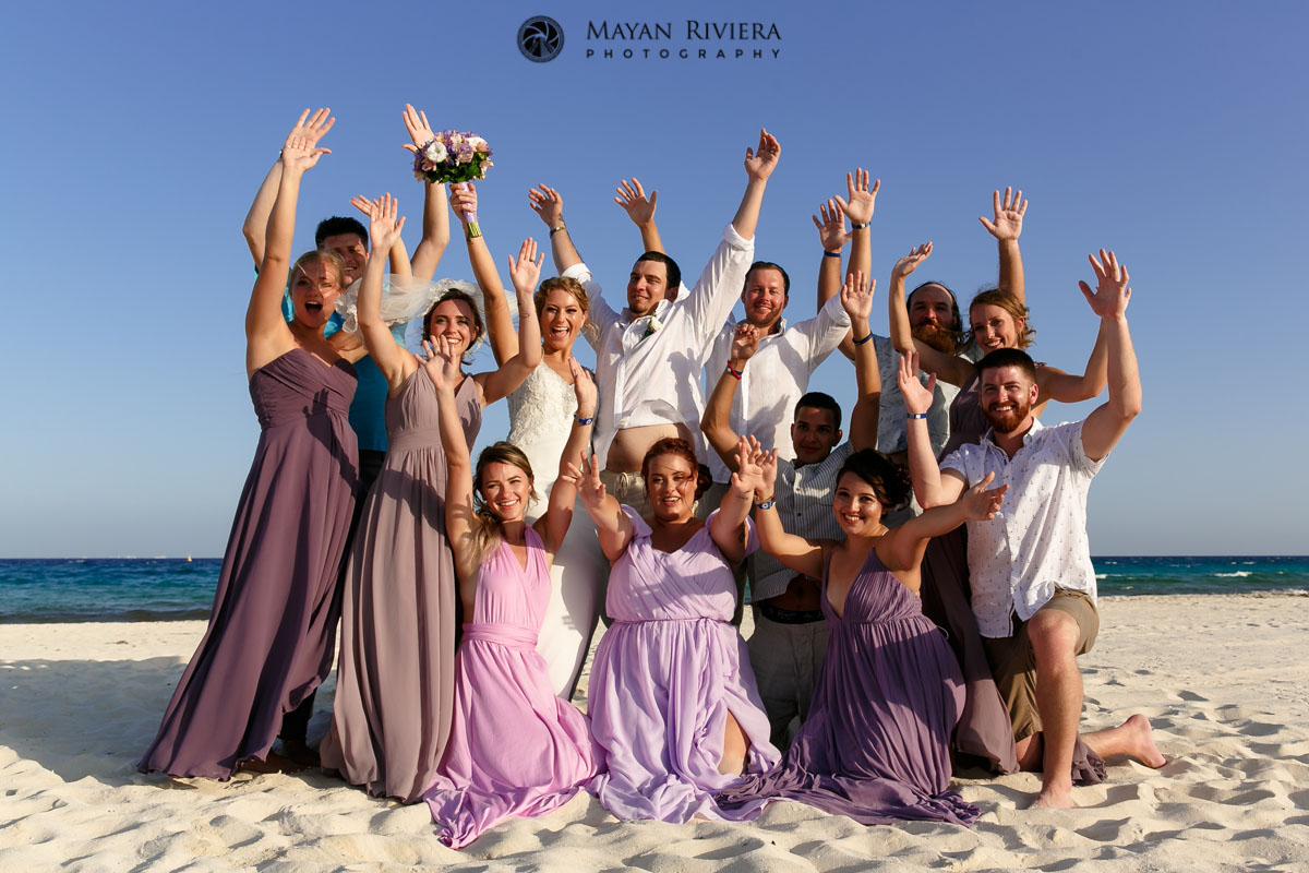 GuestsCheeringNewlywedsOnBeach