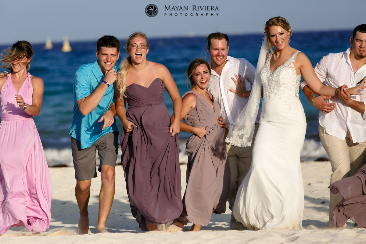 GuestsRunWithNewlywedsOnBeach