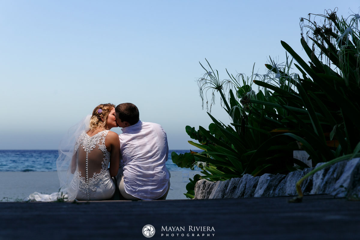 NewlywedsKissOnBeachStairs