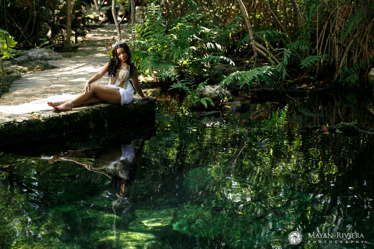 MelaniePosesInJungleGardenWithReflection