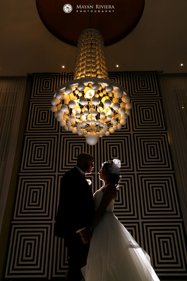 NewlywedsPoseUnderChandelier