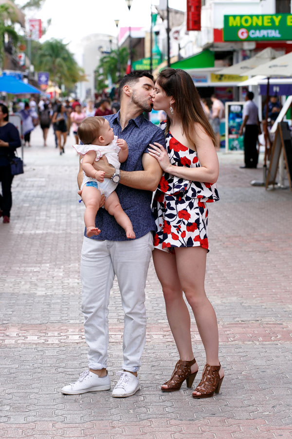 ProudPapaHoldsPreciousDaughterKissingMama
