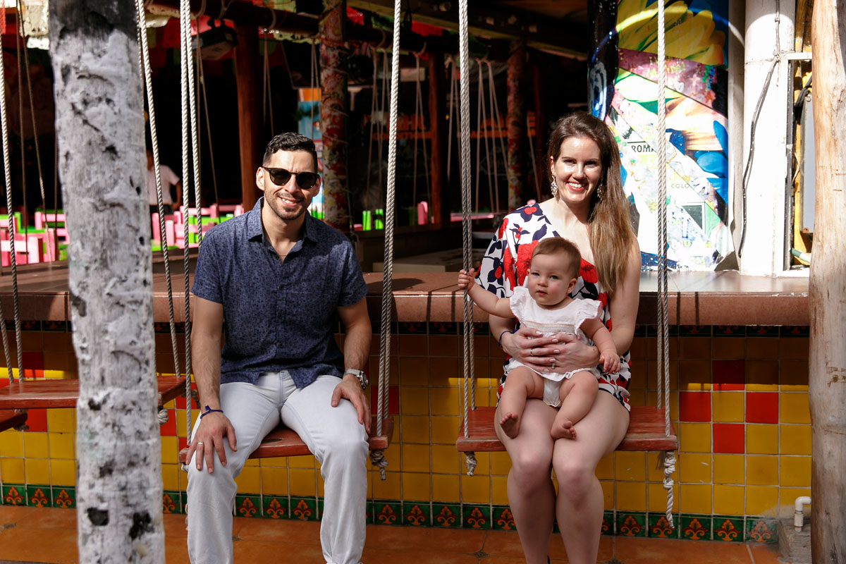 MamaHoldsBabyOnBarSwing