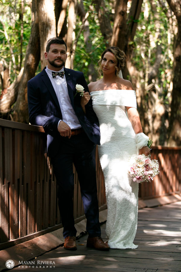 WeddingCouplePosesOnBridge
