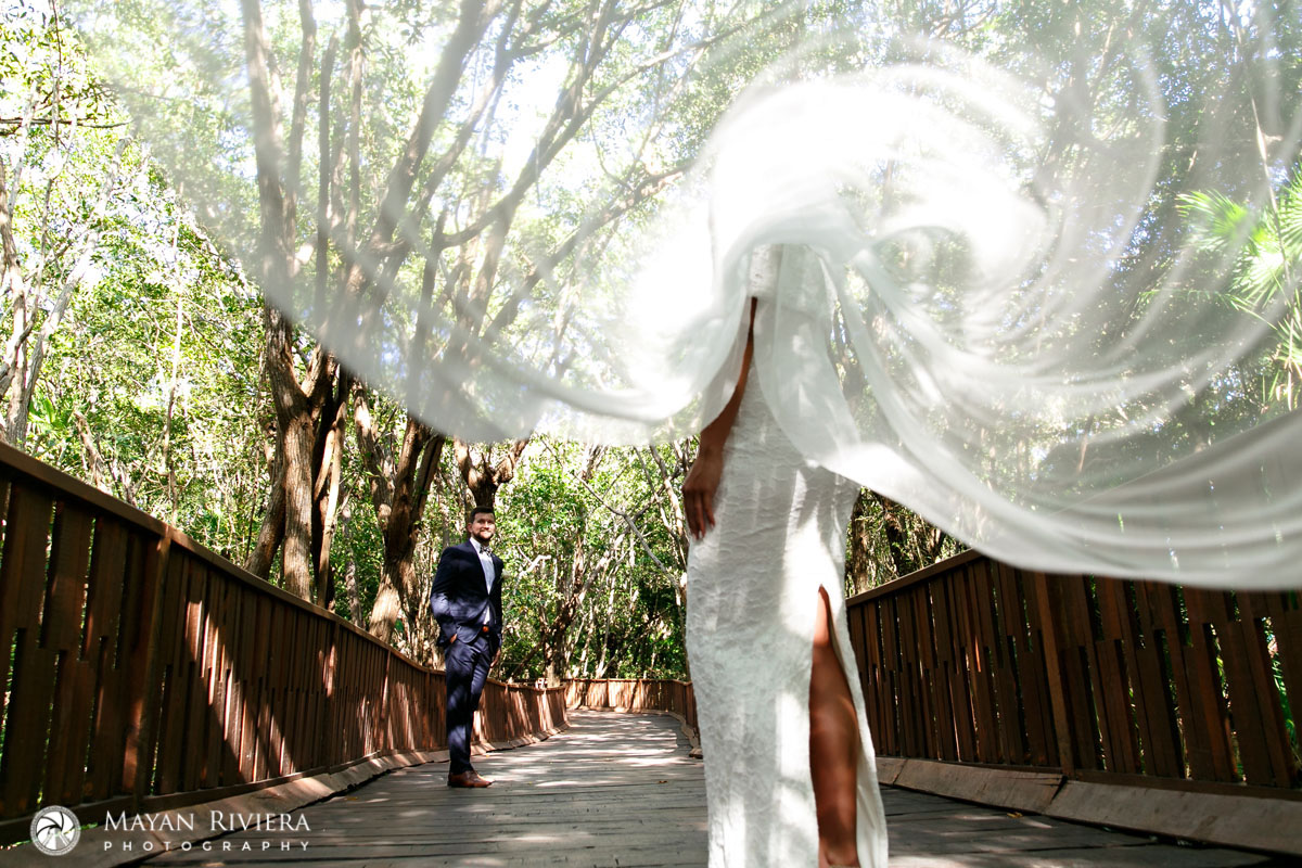 GroomWatchesBridesVeilBillowing