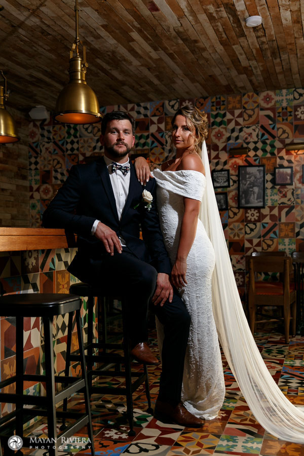 NewlywedsPoseInColorfulBar
