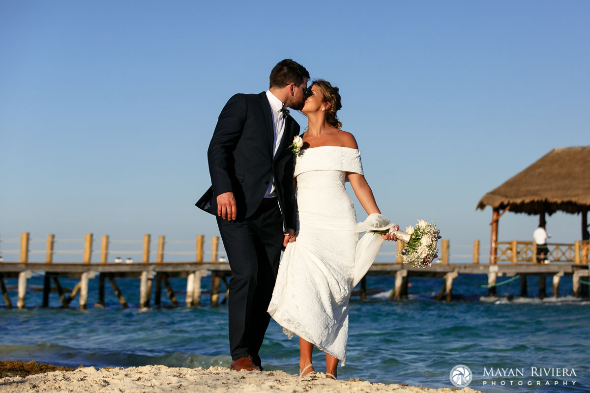 NewlywedsKissOnBeach