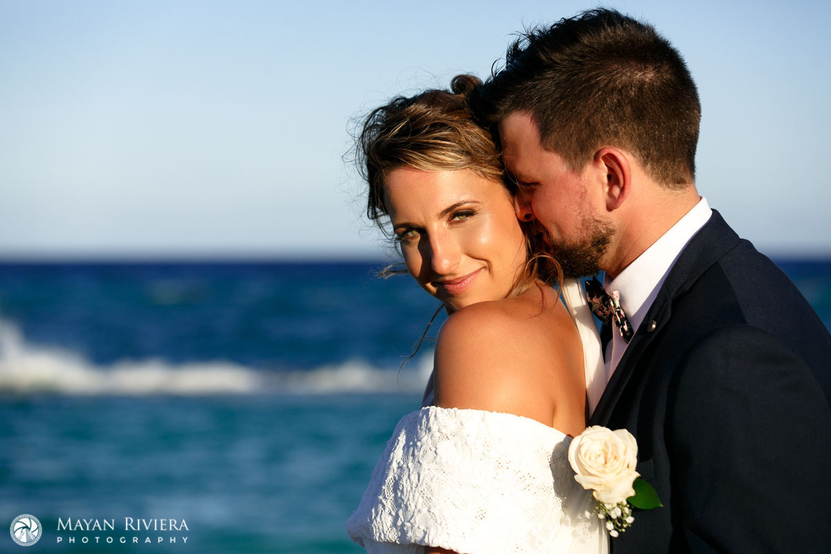 NewlywedsNuzzleOnBeach