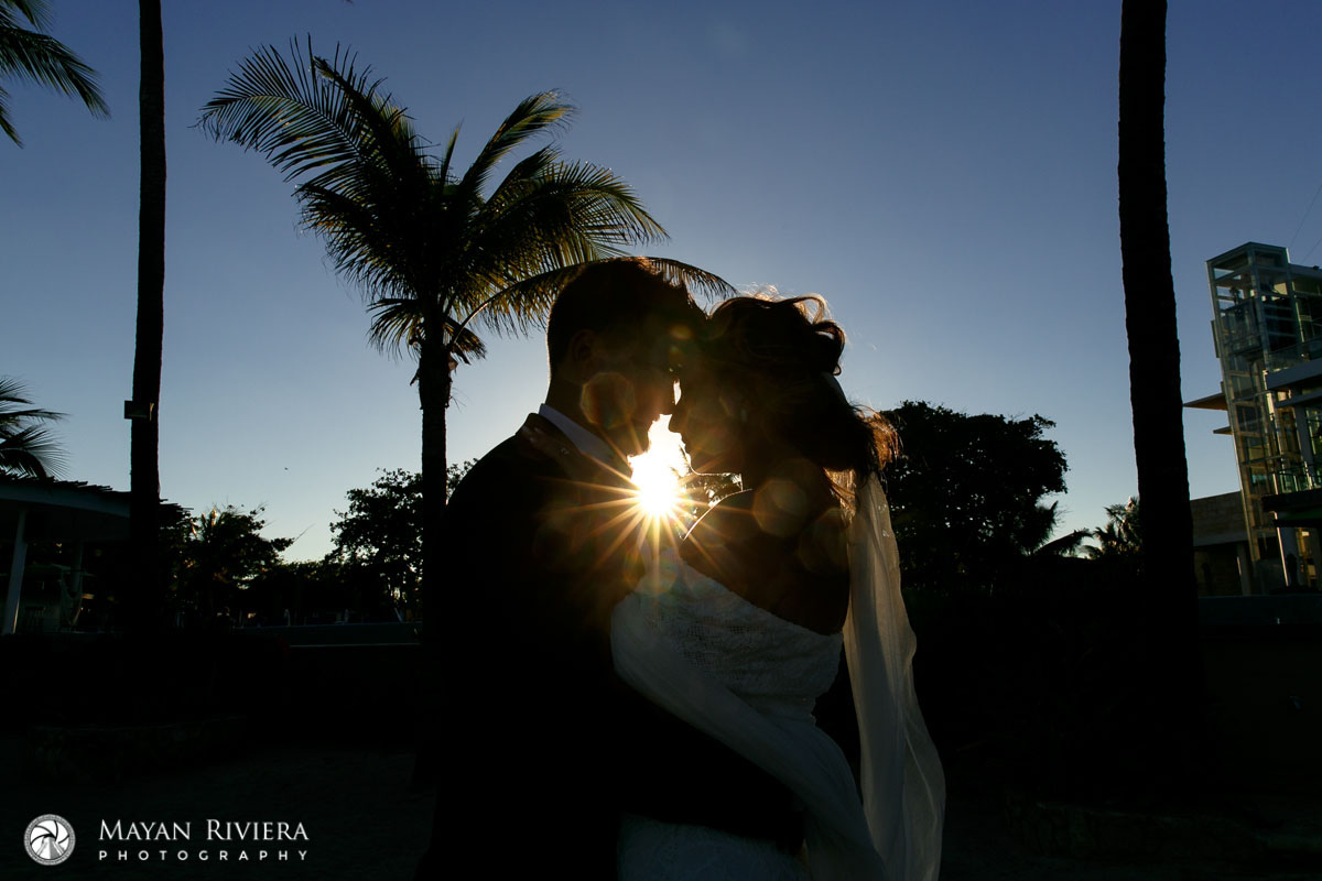 NewlywedsNuzzleShilouettedBySun