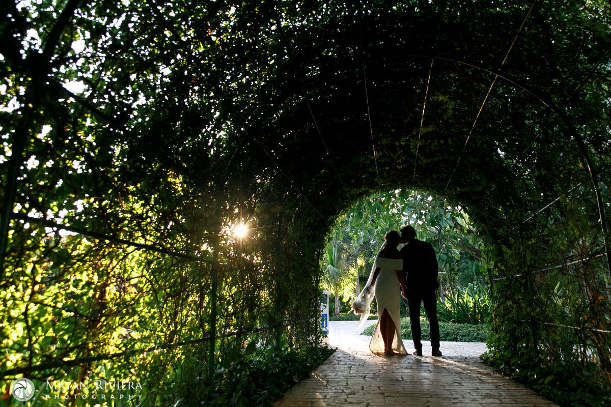 NewlywedsKissInVineTunnel