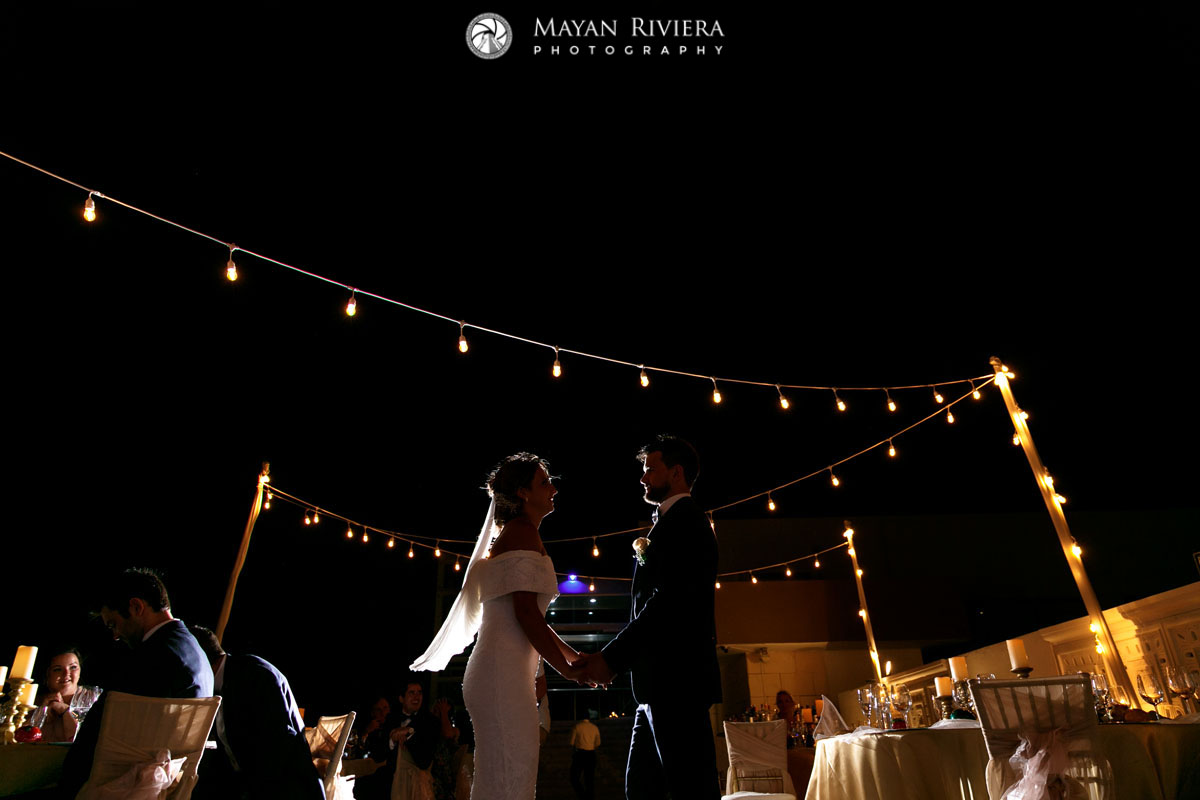 NewlywedsHoldHandsOnDanceFloor