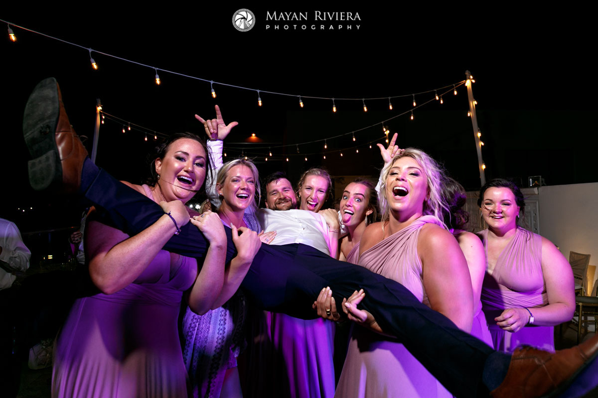 LaughingBridesmaidsHoistUpGroom