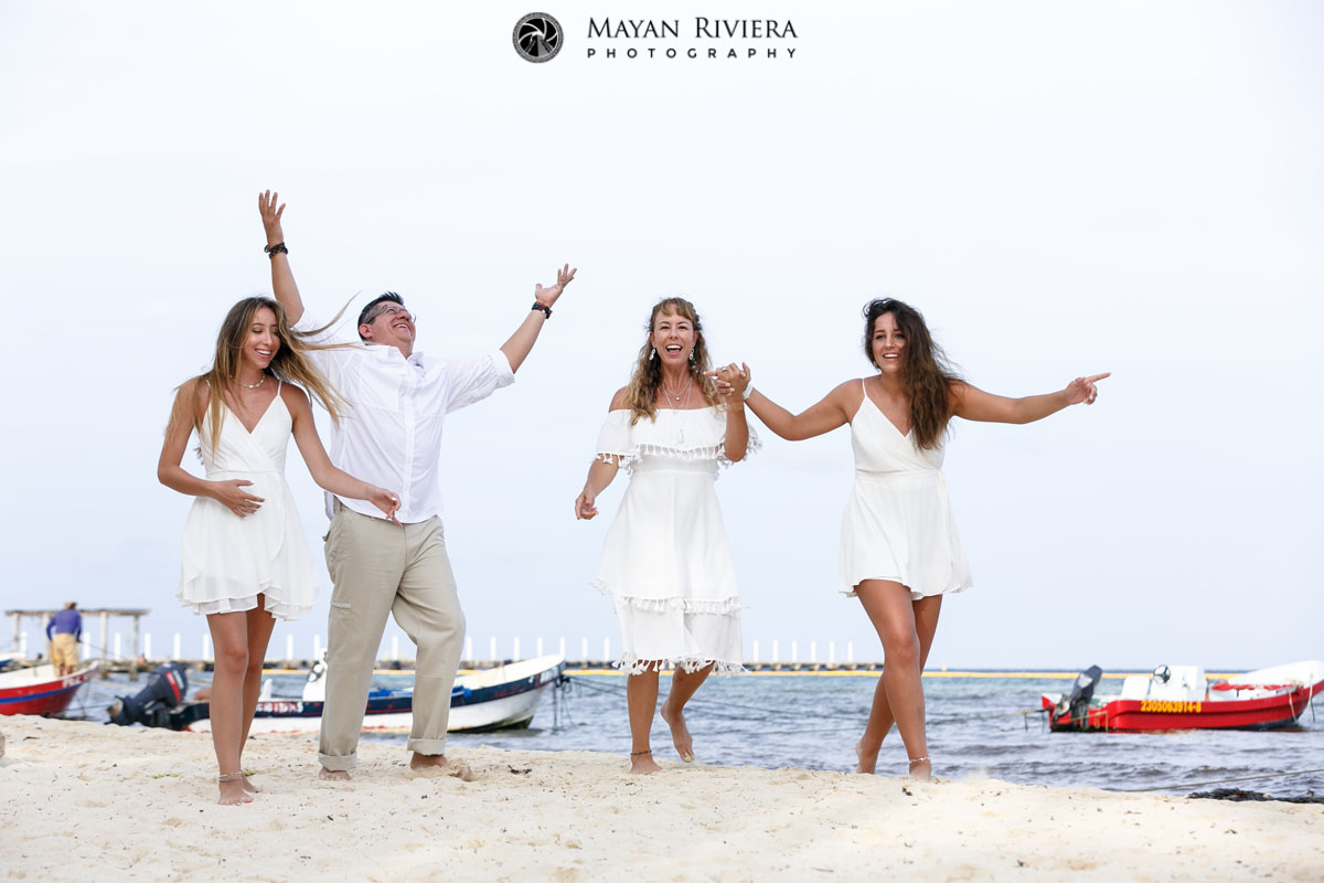 CheeringDadWalksWithFamilyOnBeach