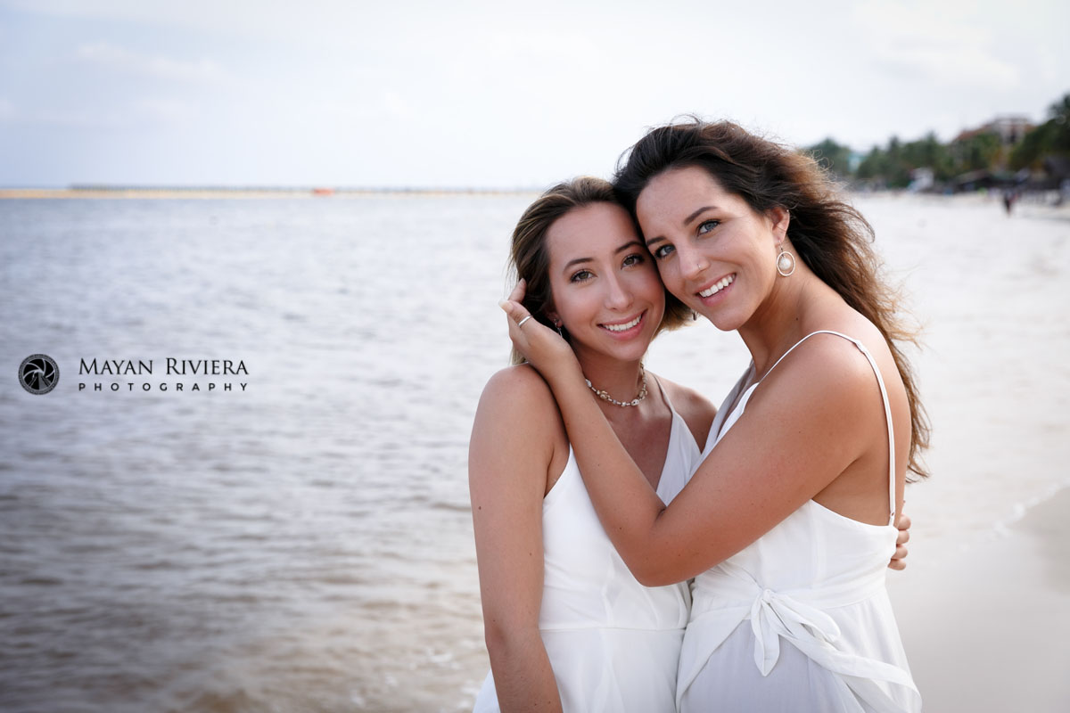 SmilingSistersPoseTogetherOnBeach