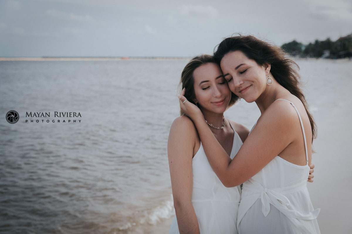 SmilingSistersPoseTogetherOnBeach