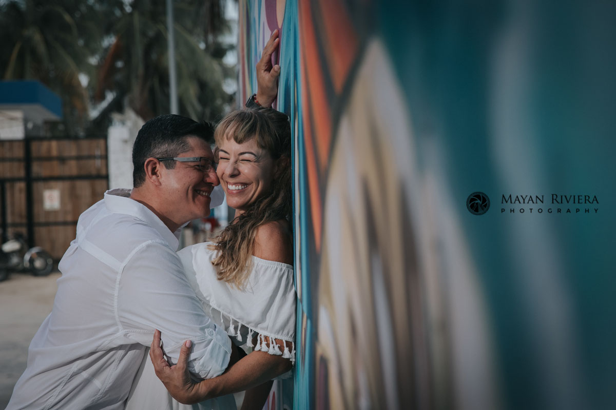 LaughingParentsPoseByGraffitiWall