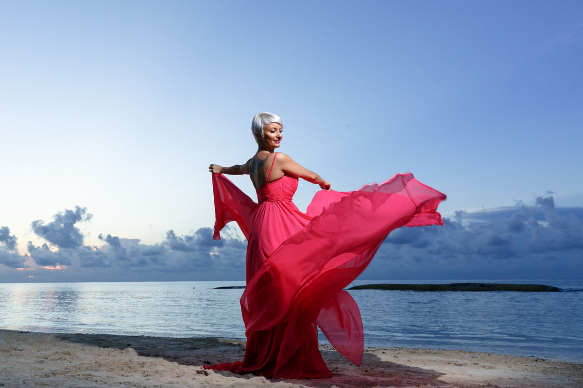 GitaTwirlsHerDressOnBeachtAtSunrise