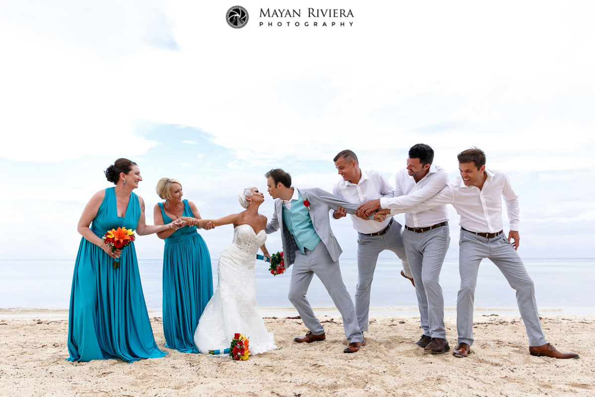 WeddingEntouragePullApartNewlywedsOnBeach