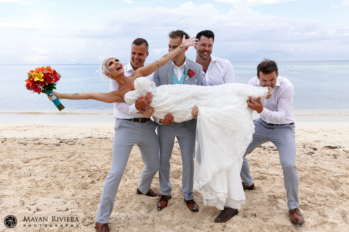 GuysHoldRecliningGitaInTheirArmsOnBeach