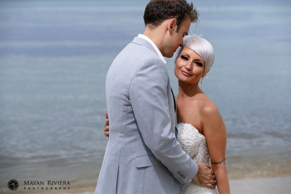 NewlywedsEmbraceEachOtherOnBeach