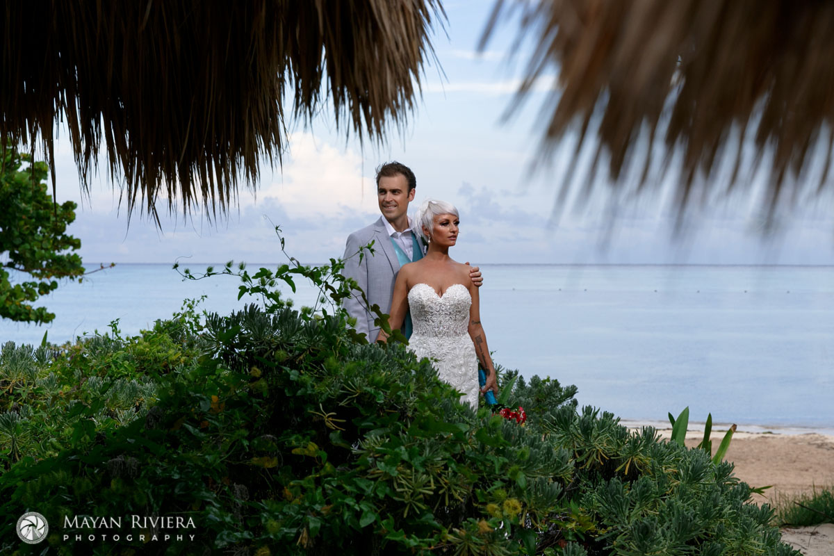 NewlywedsEmbraceEachOtherOnBeach