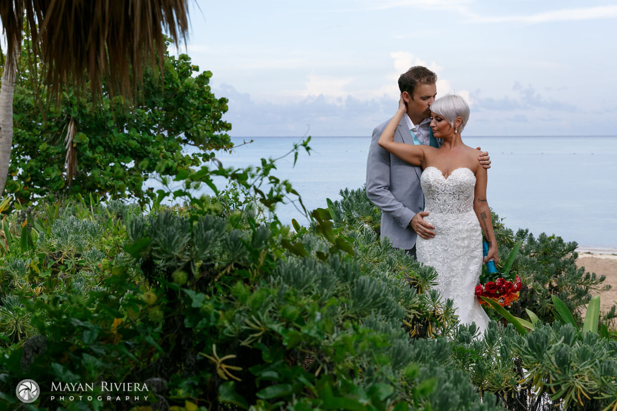 NewlywedsEmbraceEachOtherOnBeach