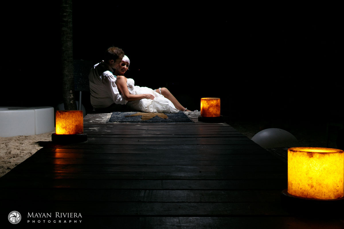 NewlywedsEmbraceOnBeachDeck