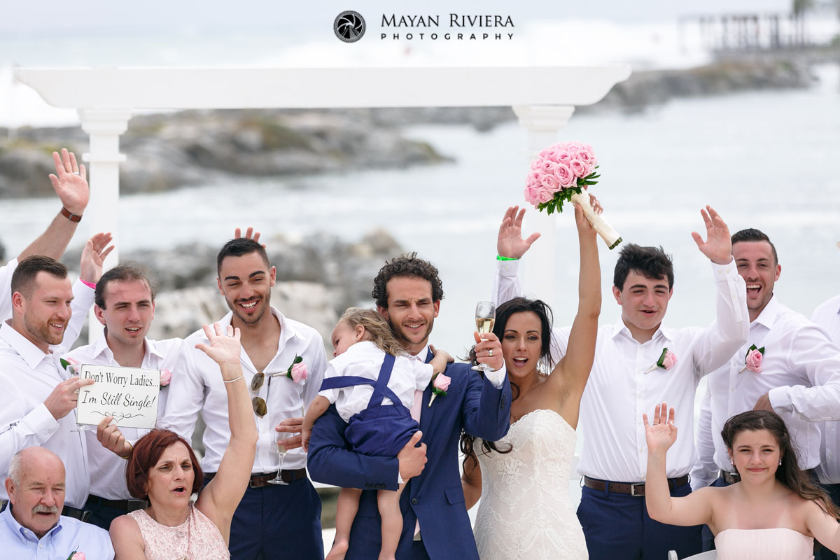 WeddingGuestsCheerNewlywedsOnBeach