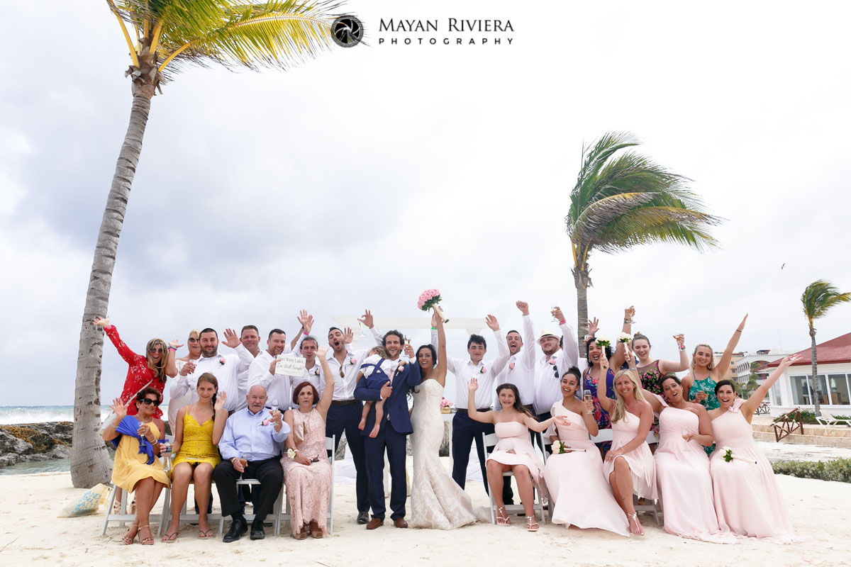 WeddingGuestsCheerNewlywedsOnBeach