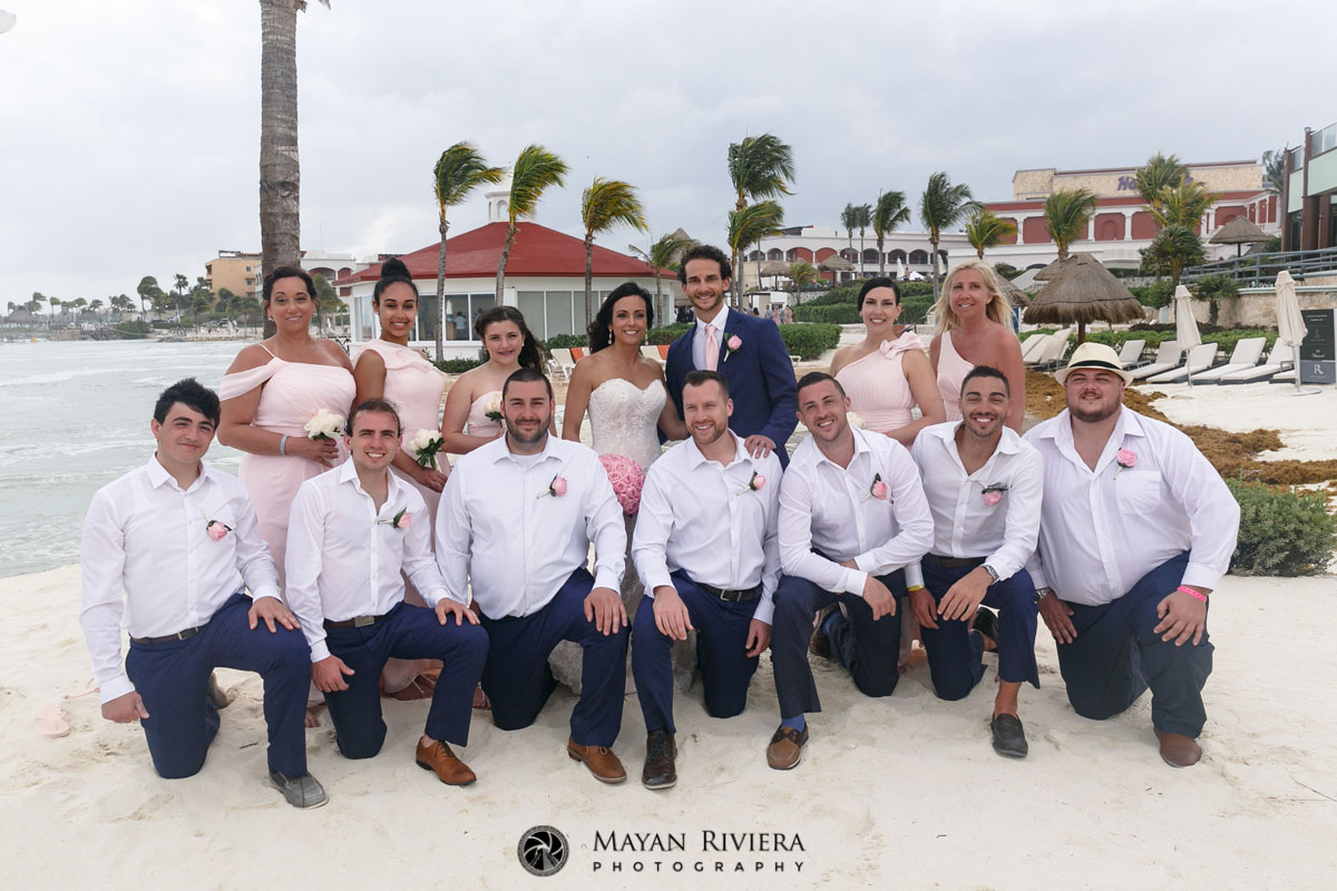 NewlywedsPoseWithWeddingPartyOnBeach