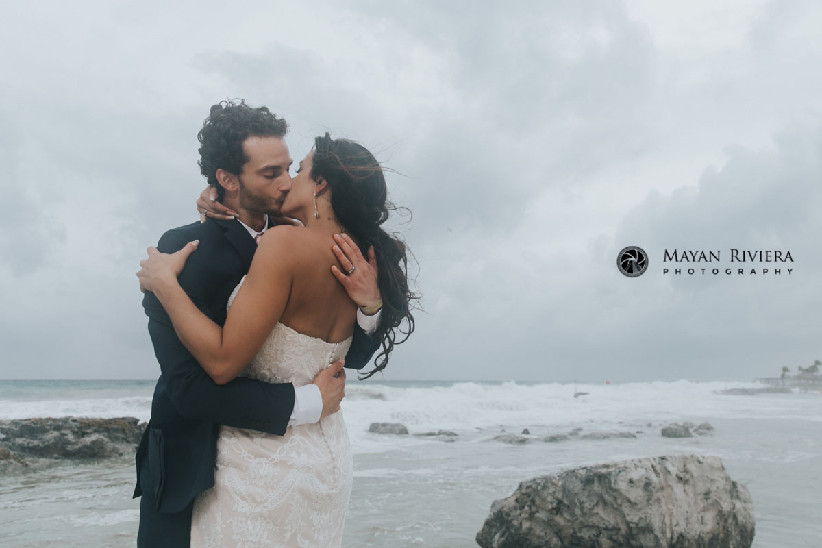 GroomKissesBrideOnBeach