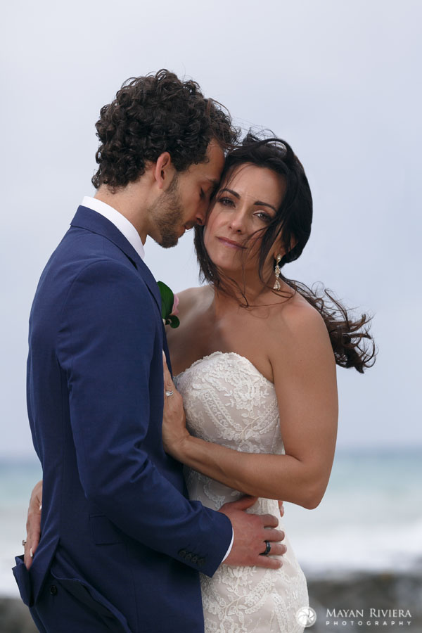 GroomHoldsBrideStandingOnRock